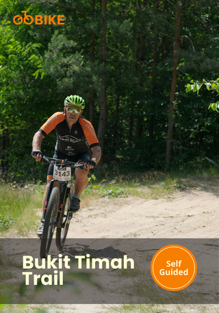 Person riding a bicycle on the Bukit Timah trail with GoBike.