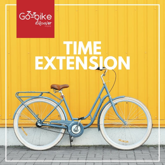 A GoBikeSG Per Hour Extension is leaning against a yellow wall in Singapore.
