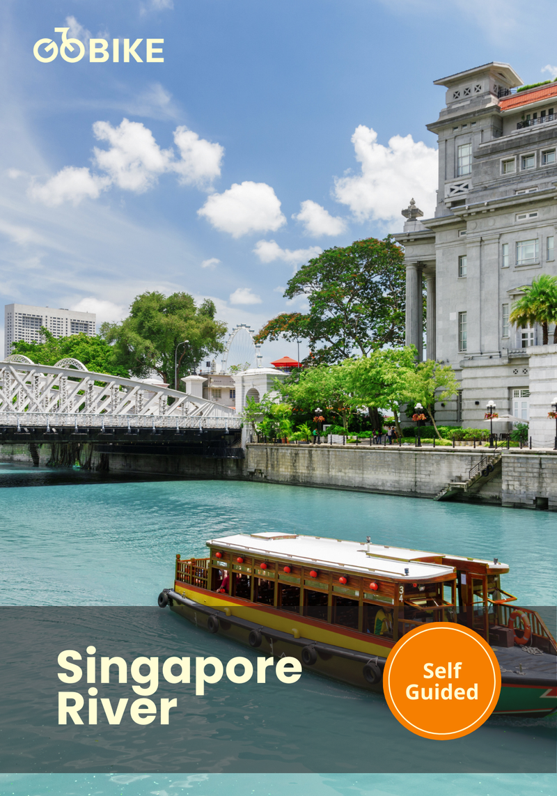 Singapore River with a boat and historic building under a blue sky with GoBike Singapore.